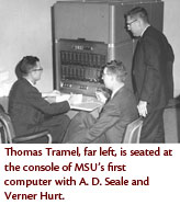Thomas Tramel, far left, is seated at the console of MSU's first computer with A. D. Seale and Verner Hurt.